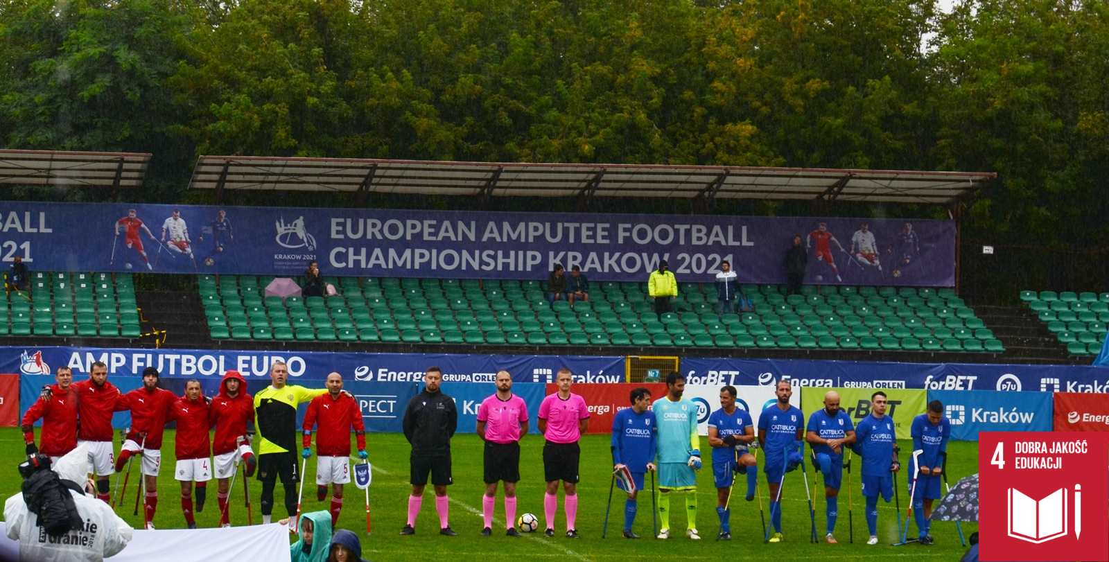 Na zdjęciu widoczne są 2 drużyny piłki nożnej w AMP Futbolu wraz z sędziami tuż przed rozpoczęciem meczu