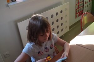 Na zdjęciu wychowanka gra w grę edukacyjną związaną z marchewką